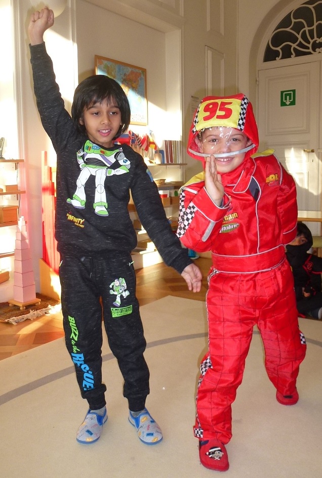 Two boys smiling and posing for the camera in their carnival costumes.