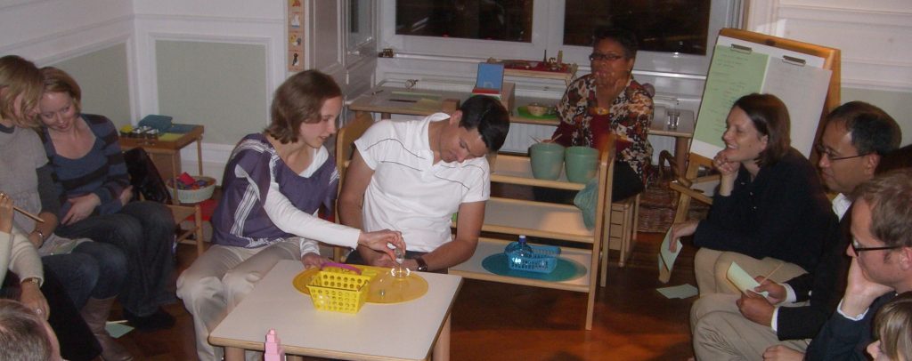 Parents are testing out some of the Montessori materials from the classroom.