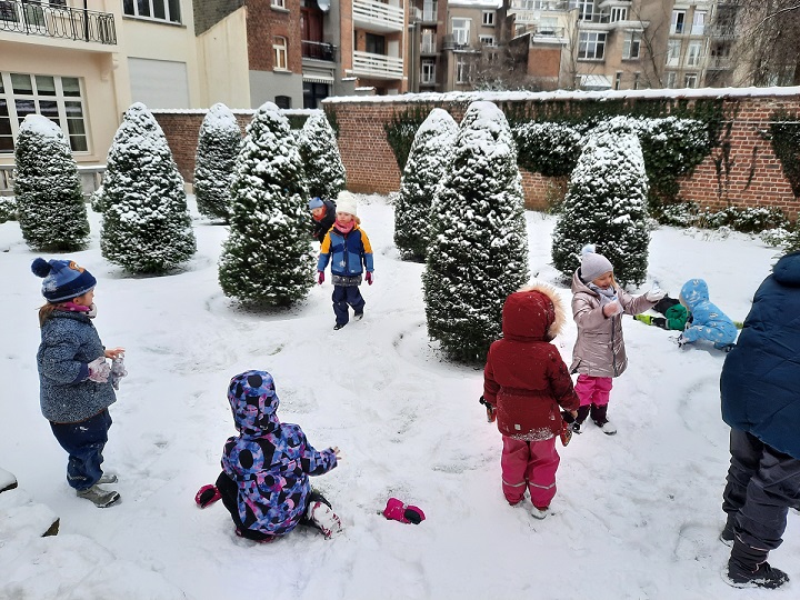 Children playing outside in the snow.
