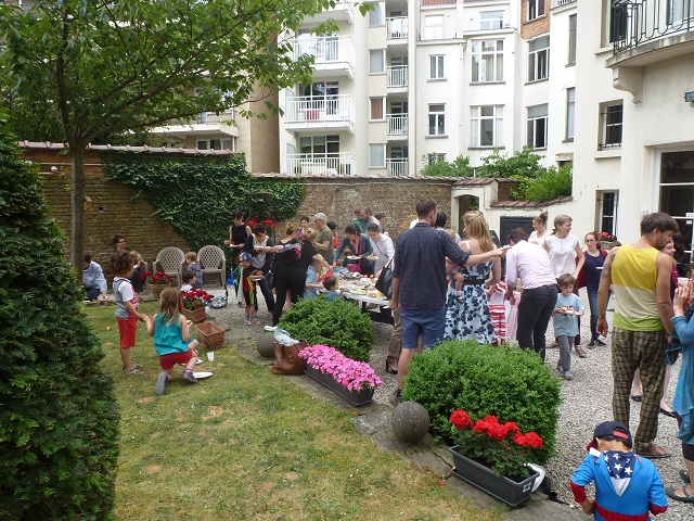 Families are enjoying food in the garden and visiting the school.