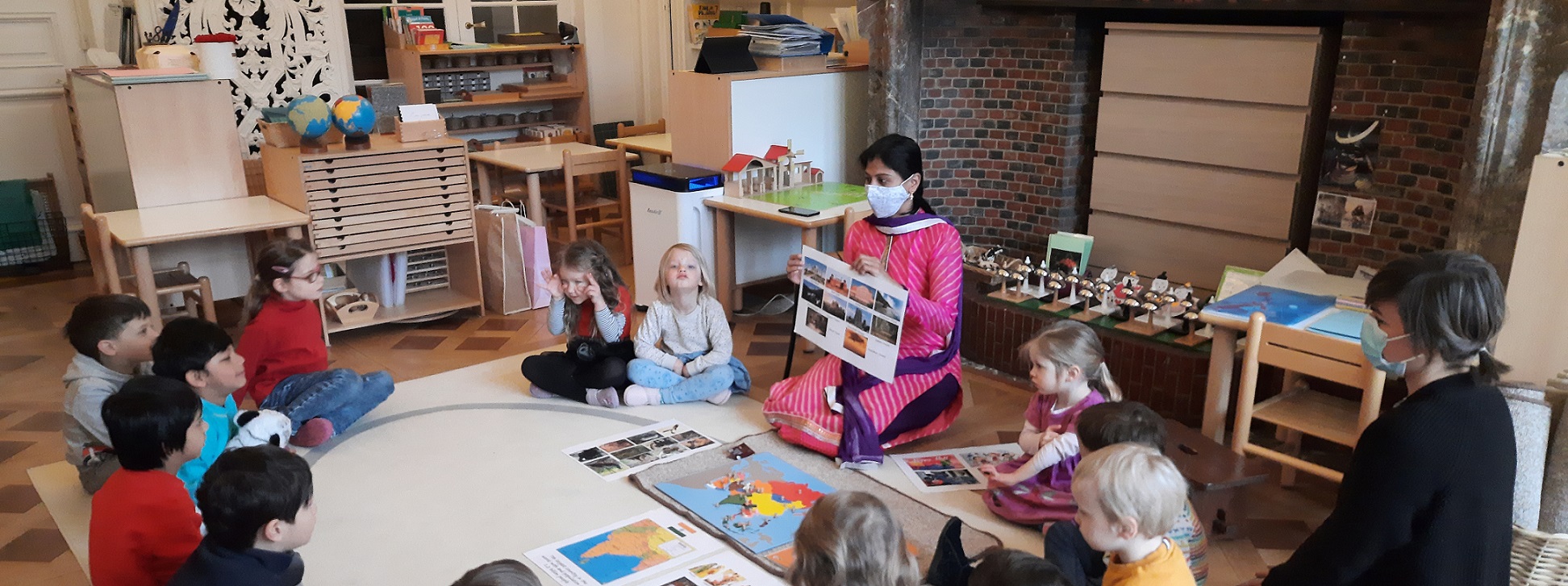 A parent showing children what her home country is like.